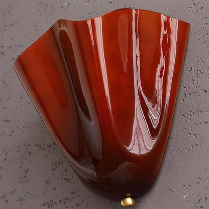 Marbled red and white object on a gray surface