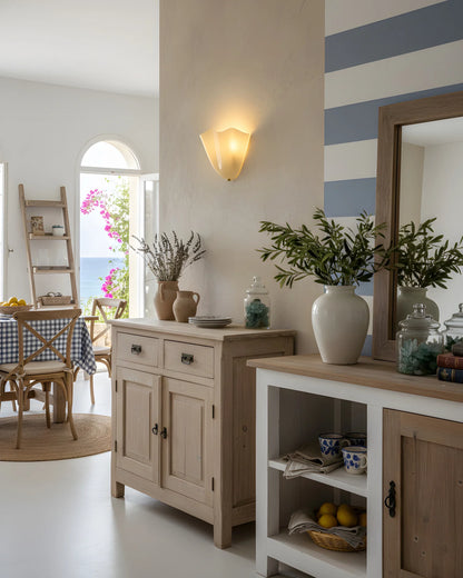 Nautical-themed room with striped wall, wooden furniture, and decorative plants.