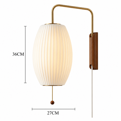 A wall-mounted light fixture with a ribbed white oval shade, gold-toned metal arm and pull chain, and a brown wood backplate, shown on a white background with dimension labels reading 36CM and 27CM.