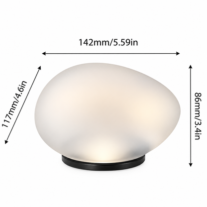 A small oval table lamp with a frosted white glass shade and a black circular base, shown with dimension arrows and labels indicating 142mm width and 86mm height on a white background.